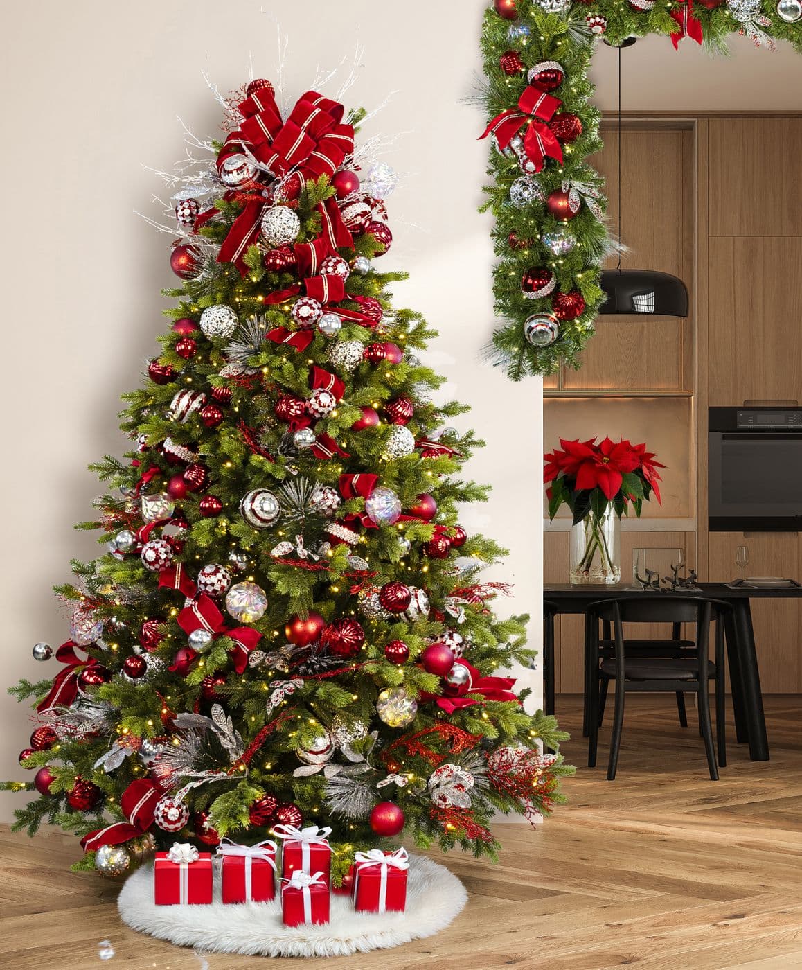 A tall tree in red and silver beside a doorway dressed with matching garland