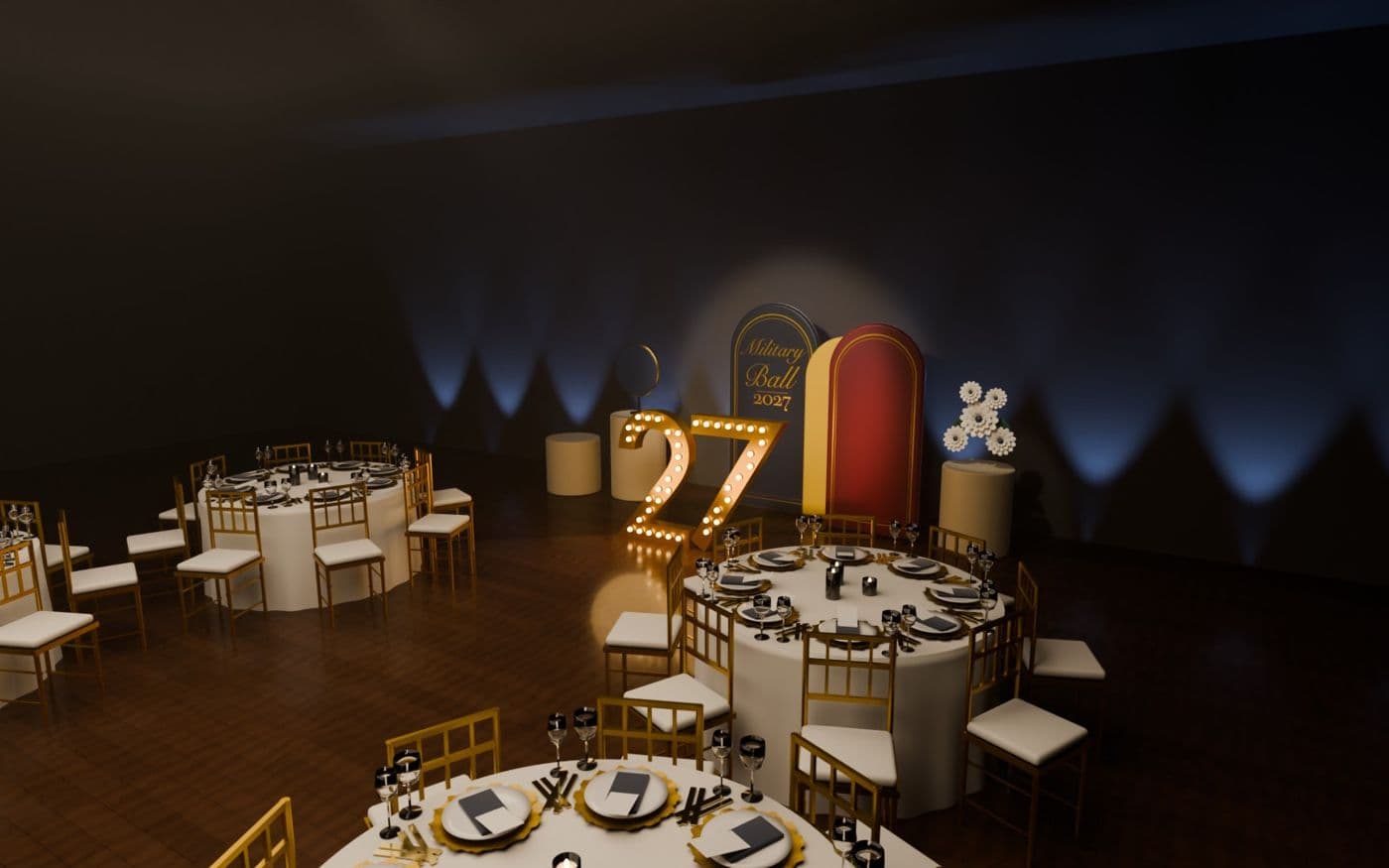 A military ball room: round tables set in gold and black, lit 27 letters and arch backdrops
